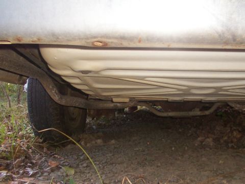 1991 Ford LTD Crown Victoria - The undercarriage of a vehicle, including the fuel tank and exhaust system, is shown from an unknown model year.