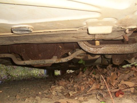1991 Ford LTD Crown Victoria - The underside of a vehicle, showing significant rust on the differential and exhaust components.