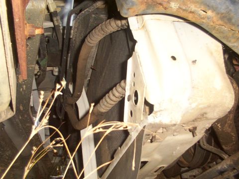 1991 Ford LTD Crown Victoria - Underside view of engine bay components, including radiator and hoses.