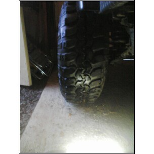 2004 Jeep Wrangler - A close-up view of a off-road tire mounted on a vehicle.