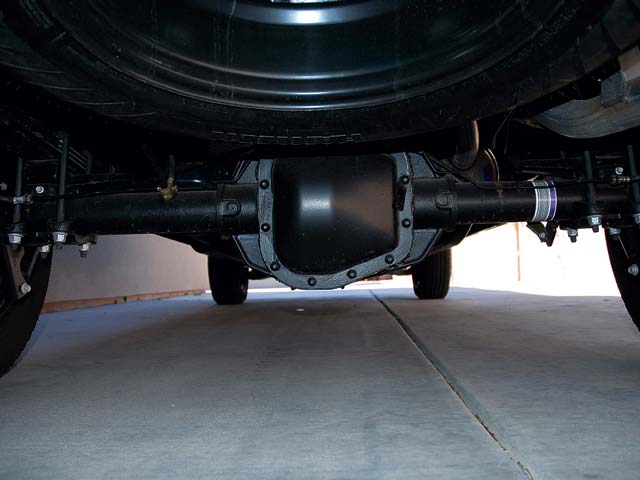 Rear axle and differential assembly with leaf springs and spare tire above
