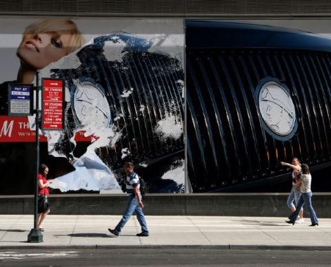 2003 Mercury Marauder - A billboard displays a car's grille and a woman's face, with pedestrians on the street below.