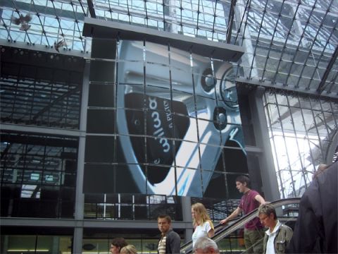 2003 Mercury Marauder - A large digital display shows a close-up of a car wheel, with people on an escalator in the foreground.