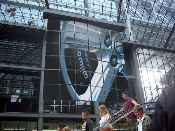 Close-up of a car wheel on a large digital display