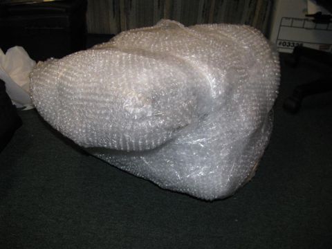 2003 Mercury Marauder - A part is wrapped in bubble wrap and placed on a carpeted floor.