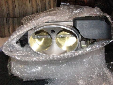 2003 Mercury Marauder - A new throttle body is shown, wrapped in protective bubble wrap, ready for installation.