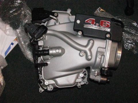 2003 Mercury Marauder - Close-up of a silver intake manifold with a black '4.6 High Performance' cover.