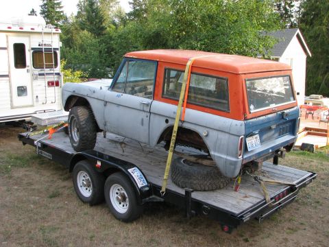 1967 Ford Bronco - A 1967 Ford Bronco, in primer gray and orange, is secured to a trailer for transport.