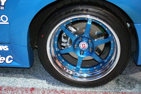 1998 Ford Crown Victoria - Close-up of a blue aftermarket wheel with HRE logo on a blue vehicle.