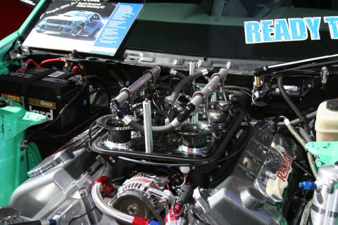 1998 Ford Crown Victoria - The engine bay features a highly modified V8 engine with custom components and bright green bodywork.