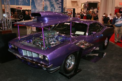 1998 Ford Crown Victoria - Custom purple drag car with a prominent engine and hood scoop on display.
