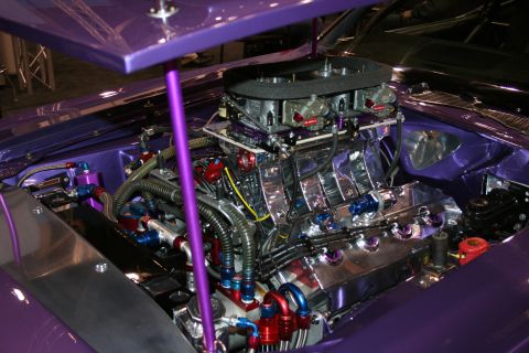 1998 Ford Crown Victoria - A highly customized engine bay with a prominent chrome engine and purple accents.