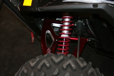 1998 Ford Crown Victoria - Close-up of a red suspension system and tire, possibly from an ATV or UTV.