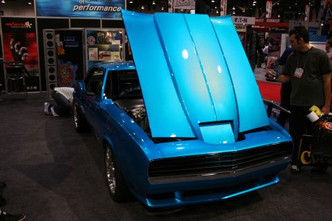 1998 Ford Crown Victoria - A bright blue classic car is displayed with its hood open, revealing the engine bay.
