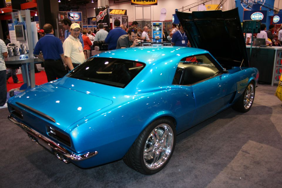 Blue 1969 Chevrolet Camaro coupe with hood open at a show