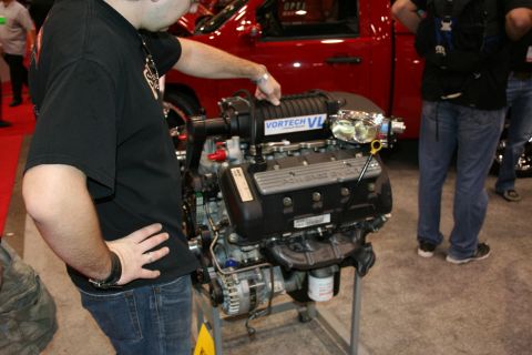 1998 Ford Crown Victoria - A Vortech VL supercharged engine is displayed, with "Powered by Ford" visible on the valve cover.