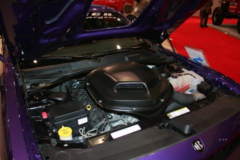 1998 Ford Crown Victoria - The engine bay of a purple car is shown with the hood open, revealing a large black air intake.
