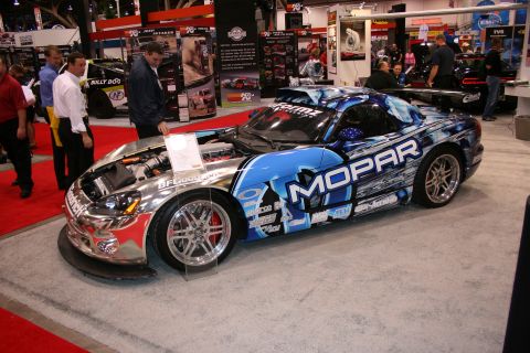 1998 Ford Crown Victoria - A highly customized Dodge Viper with a striking Mopar livery is displayed with its hood open, revealing the engine bay.
