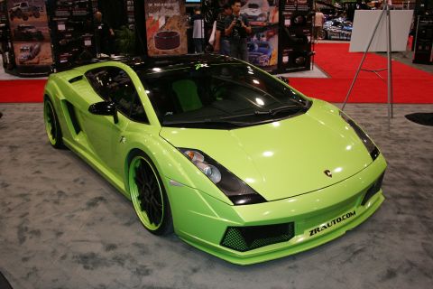 1998 Ford Crown Victoria - A lime green sports car with custom wheels and black accents is displayed at an auto show.