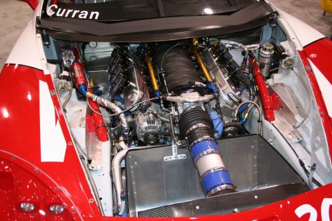 1998 Ford Crown Victoria - The intricate engine of a race car is exposed, showing custom modifications and high-performance parts.
