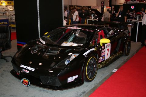 1998 Ford Crown Victoria - A black Lamborghini Gallardo GT race car is displayed indoors on a red carpet.
