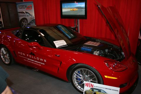 1998 Ford Crown Victoria - A red sports car is displayed with its hood open, revealing the engine compartment.