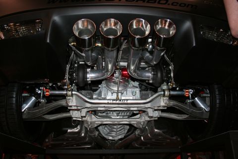 1998 Ford Crown Victoria - Custom twin-turbo setup with quad exhaust pipes visible on the underside of a performance vehicle.