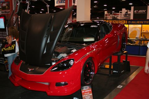 1998 Ford Crown Victoria - Red 2008 Chevrolet Corvette ZR7 #1 of 50 on display at an auto show.