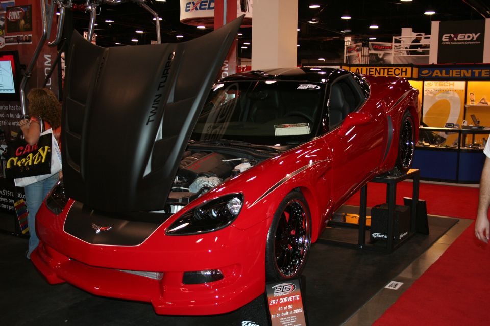 Red 2008 Chevrolet Corvette ZR7 #1 of 50 on display, hood open showing engine. Custom black wheels and hood accents