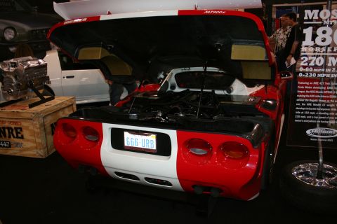 1998 Ford Crown Victoria - Sports car with open hood and exposed engine bay, displayed at an event.