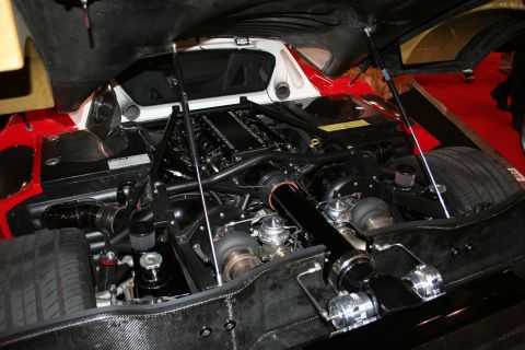 1998 Ford Crown Victoria - The engine bay of a custom vehicle is shown, twin turbochargers and extensive carbon fiber construction.