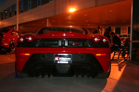 1998 Ford Crown Victoria - A red Ferrari F430 is parked at night, with another red car visible to the left.