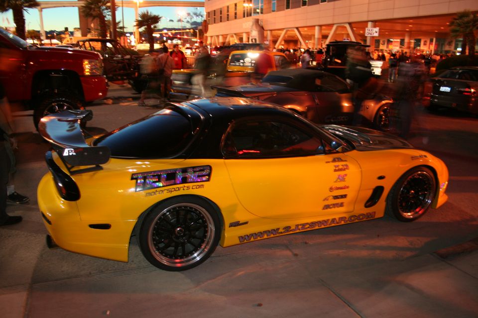 Yellow sports car with black roof and spoiler, covered in decals and racing sponsors. Website www.2jdsrwar.com visible