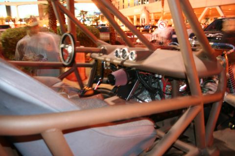 1998 Ford Crown Victoria - The interior of a custom dune buggy is visible, a roll cage, steering wheel, and dashboard gauges.