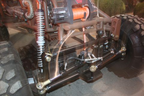 1998 Ford Crown Victoria - Close-up of the front suspension and winch system on a custom off-road vehicle.