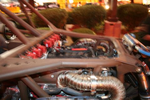1998 Ford Crown Victoria - Close-up view of a custom engine bay with a prominent roll cage structure.
