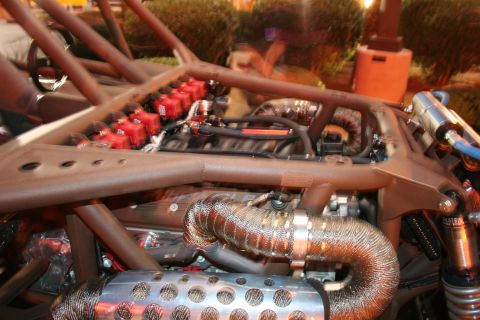 1998 Ford Crown Victoria - Close-up view of a custom dune buggy's engine bay, highlighting the ignition system and exhaust components.