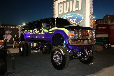 1998 Ford Crown Victoria - This heavily modified Ford Super Duty truck features custom paint and a lifted suspension with dual rear wheels.