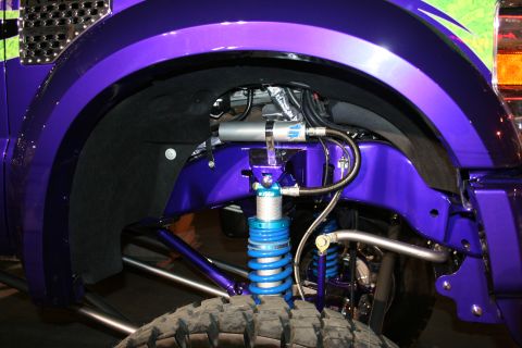 1998 Ford Crown Victoria - Custom suspension components on a purple truck are visible, including coilovers and a shock reservoir.