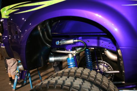 1998 Ford Crown Victoria - Custom suspension components and a large tire are visible on a modified truck.
