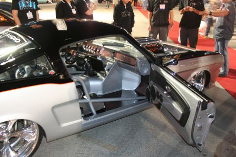 1998 Ford Crown Victoria - Interior view of a heavily modified coupe with a roll cage and custom audio system.