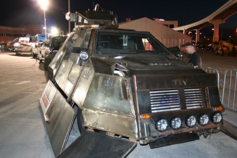 1998 Ford Crown Victoria - This heavily modified vehicle, possibly a TIV, features extensive armor plating and auxiliary lighting, with its side doors ajar.