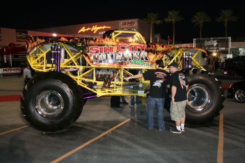 1998 Ford Crown Victoria - A custom monster truck named "Sin City Crusher" is displayed outdoors with spectators nearby.