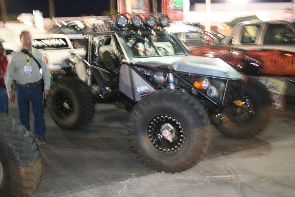 Off-road buggy with large tires and roll cage