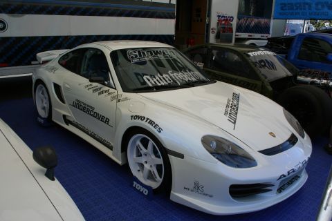 1998 Ford Crown Victoria - A white Porsche 911 is adorned with numerous racing decals and aftermarket parts.