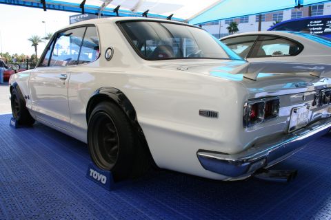 1998 Ford Crown Victoria - A white classic Japanese coupe is shown from the rear, with a spoiler and wide fender flares.