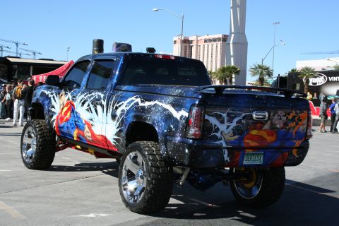 1998 Ford Crown Victoria - A heavily customized pickup truck features a full Superman-themed paint job and large chrome wheels.