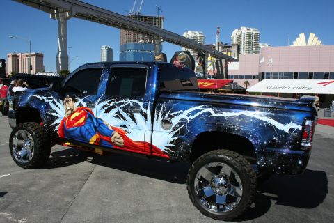 1998 Ford Crown Victoria - A customized pickup truck with a Superman graphic and a starry sky paint job is parked outdoors.