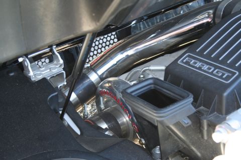1998 Ford Crown Victoria - Close-up of engine bay components, including chrome piping and a "FORD GT" branded cover.