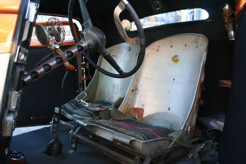 1998 Ford Crown Victoria - Custom hot rod interior features airplane seats and a vintage steering wheel with a small fan.